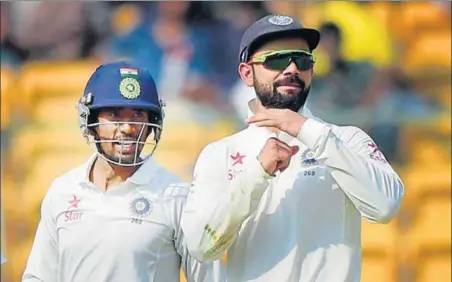  ?? PTI PHOTO ?? India captain Virat Kohli asks for a review as wicketkeep­er Wriddhiman Saha looks on during the second day of the second Test in Bangalore on Sunday.