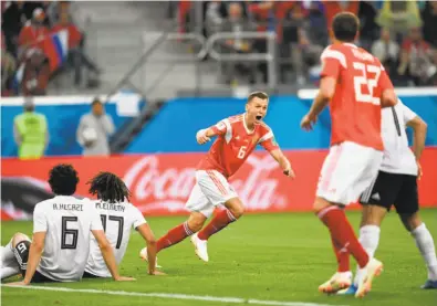  ?? Gabriel Bouys / Getty Images ?? Denis Cheryshev (center) scored in the 59th minute for Russia, which turned a scoreless game at halftime into a rout of Egypt. In its first two games, the Russians have outscored their opponents 8-1.