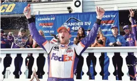  ?? ASSOCIATED PRESS ?? Denny Hamlin celebrates in Victory Lane after winning the NASCAR Gander RV 400 at Pocono Speedway.