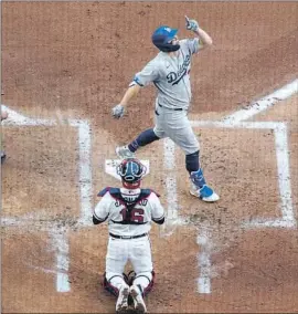  ?? JOC PEDERSON CROSSES ?? the plate after his three- run homer gave the Dodgers a 5- 0 lead in the f irst inning. Pederson added three singles in L. A.’ s romp.