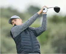  ?? DAN MULLAN/GETTY IMAGES ?? Jordan Spieth tees off on the second hole Thursday. He shares the lead, despite not playing competitiv­ely in weeks.