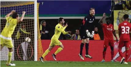  ??  ?? Simon’s sickener: Mignolet protests in vain for offside as Adrian Lopez celebrates Villarreal’s late winner