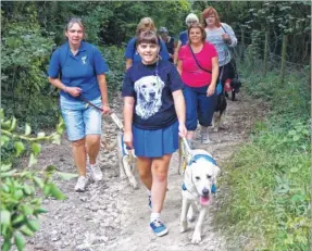  ??  ?? Grace Newcombe leading the field of supporters at the Dogs Unite charity event in aid of Guide Dogs