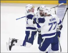  ?? Canadian Press via AP ?? LEAPING FOR JOY — The Lightning’s Jan Rutta (44) celebrates his goal against the Montreal Canadiens with Ondrej Palat (18) and Victor Hedman (77) during the first period of Game 3 of the Stanley Cup Final on Friday in Montreal. Tampa Bay won 6-3 to take a 3-0 series lead.