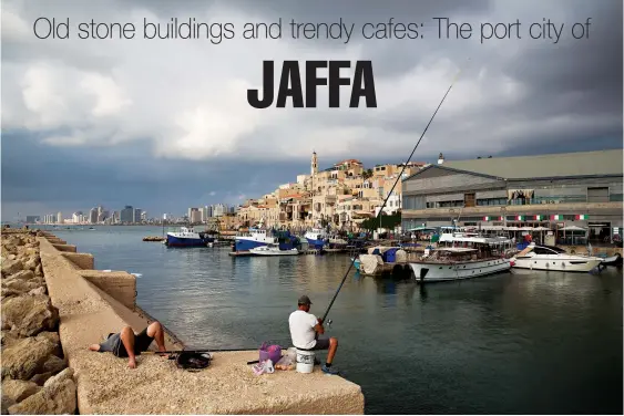  ?? Oded Balilty/Associated Press ?? ■ Fishermen cast their rods July 28 in the port of Jaffa, Israel. Today glass towers and modern apartment complexes rise amid Jaffa’s old white stone buildings. It’s famous for its flea market and hummus cafes. Although Jaffa is an ancient place, visitors will find trendy bars, galleries and boutiques.