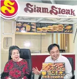  ?? ?? From left, Mrs Chamchan and Mr Supak. Steak Group, the owner of EZ’S sausage and the operator of Siam Steak burger chain, announced the expansion of its business via the franchise model to turnaround business.