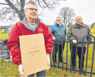  ?? TINA COMEAU ?? Chebogue Cemetery trustees Brian Duncan and Blair Boudreau, along with cemetery president Bill Tower, stand at the gates of the historic Yarmouth County cemetery located on the Town
Point Road. Duncan holds a record book of burials dating back to 1772.