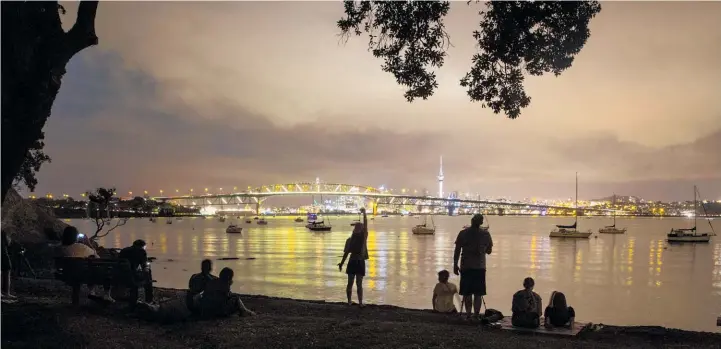  ?? Peter Meecham ?? Auckland Harbour Bridge showed its new colours to thousands of fans last night, including PM Jacinda Ardern and her partner Clarke Gayford.