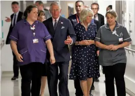  ??  ?? Britain’s Prince Charles, Prince of Wales, and Britain’s Camilla, Duchess of Cornwall, talk to staff during a visit to the Royal London Hospital to meet those injured in the London attack on Tuesday. — AFP