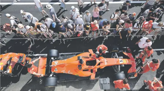  ?? Picture: AFP ?? EYE CANDY. Fans check out Sebastian Vettel’s Ferrari in the pit lane of the Circuit Paul Ricard in Le Castellet, southern France, ahead of the French Formula One Grand Prix.