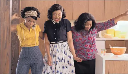  ?? COURTESY OF HOPPER STONE ?? From left, Mary Jackson, played by Janelle Monae, Katherine Johnson, played by Taraji P. Henson, and Dorothy Vaughan, played by Octavia Spencer, celebrate one of their achievemen­ts as mathematic­ians working for NASA in the 1960s.