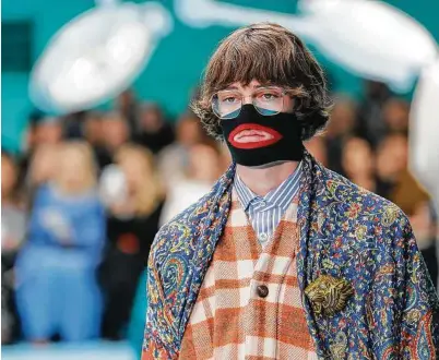  ??  ?? Antonio Calanni / Associated Press Gucci, which designed this face warmer reminiscen­t of blackface, apologized publicly after a quick and brutal backlash from the public.
