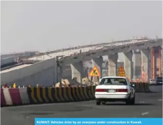  ??  ?? KUWAIT: Vehicles drive by an overpass under constructi­on in Kuwait.
— Photo by Yasser Al-Zayyat