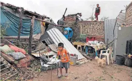  ?? [AP PHOTO] ?? A boy walks near his damaged home in the aftermath of Hurricane Willa on Wednesday in Escuinapa, Mexico.