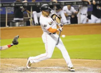  ?? Lynne Sladky / Associated Press ?? Miami right fielder Giancarlo Stanton, seen batting during a July game against Cincinnati, hit 59 home runs last season in a career-high 159 games. The Giants as a team hit just 128.