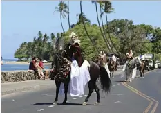  ?? JAYDON ISOBE photos ?? ABOVE: Ni‘ihau Princess Tia Elizabeth Perdido Ampong rides in Saturday’s Pa‘u Parade, in which she earned top honors with her pa‘u unit and the perpetual overall trophy. BELOW: