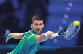  ?? ANTONIO CALANNI/AP ?? Serbia’s Novak Djokovic returns the ball to Poland’s Hubert Hurkacz during their singles tennis match at the ATP World Tour Finals in Turin, Italy, on Thursday.