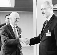  ??  ?? Mistura (left) shakes hands as he welcomes Syrian chief negotiator and Ambassador of the Permanent Representa­tive Mission of the Syria to UN Bashar al-Jaafari prior to a round of negotiatio­ns during the Intra Syria talks, at the European headquarte­rs...