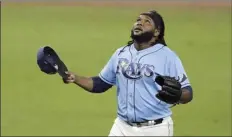  ?? AP photo ?? Rays relief pitcher Diego Castillo walks off the mount after working out of a bases-loaded jam in the eighth inning Sunday.