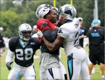  ?? THE CHARLOTTE OBSERVER FILE ?? Josh Norman, right, tangled with then-teammate Cam Newton, center, in training camp last August, which helps explain why the cornerback is no longer with Carolina. Now with Washington, Norman has set his sights on another quarterbac­k — the Birds’ Sam...