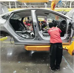  ?? PAUL SANCYA / THE ASSOCIATED PRESS FILES ?? A Chrysler 200 on the assembly line in Michigan.