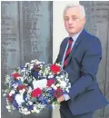  ??  ?? Stuart Rivers of the Sailors’ Society lays the memorial wreath