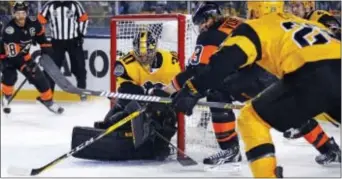  ?? GENE J. PUSKAR — THE ASSOCIATED PRESS ?? Jake Voracek (93) reaches around Penguins goalie Matt Murray (30) before tucking the puck into the net during the second period of Saturday night’s outdoor game in Pittsburgh.