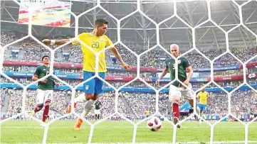  ??  ?? Quick action: Brazil’s Roberto Firmino (second left) scoring the second goal against Mexico in the last-16 match at the Samara Arena yesterday. — Reuters photo