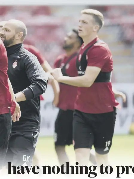  ??  ?? 2 Centre-half Scott Mckenna leads the Aberdeen team in a training session at Pittodrie ahead of tonight’s first-leg match with Burnley. Manager Derek Mcinnes, below, said the English team will provide the toughest test his team have faced in Europe.