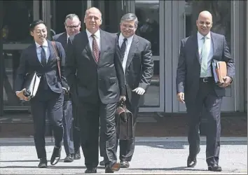  ??  ?? Thomas Zehnle, center, attorney of former Trump campaign chairman Paul Manafort, arrives with other members of the defense team at the Albert V. Bryan United States Courthouse on Monday in Alexandria, Virginia.