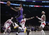  ?? MARCIO JOSE SANCHEZ — THE ASSOCIATED PRESS ?? The Lakers’ D’angelo Russell (1) soars past a trio of Raptors defenders to score during Friday night’s game.