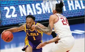  ?? (AP/Mark Humphrey) ?? LSU’s Javonte Smart (left) drives to the basket Saturday against Ethan Henderson of Arkansas during the Tigers’ 78-71 victory over the No. 8 Razorbacks in Nashville, Tenn. Smart finished with 19 points.