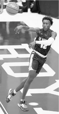  ?? STEPHEN M. DOWELL/ORLANDO SENTINEL ?? Dr. Phillips guard Abdoulaye Thiam passes during his team’s Thursday night win against Prestonwoo­d Christian Academy at The City Beautiful Invitation­al at The First Academy. The Panthers lost on Friday night to Ocoee.