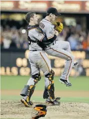  ?? LENNY IGNELZI/THE ASSOCIATED PRESS ?? San Francisco Giants starting pitcher Tim Lincecum gets lifted by catcher Buster Posey after throwing a no-hitter against the Padres in San Diego on Saturday.