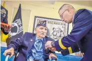  ?? ROBERTO E. ROSALES/JOURNAL ?? New Mexico National Guard Adjutant General Kenneth Nava pins medals on Bataan Death March survivor and World War II veteran Joe Romero on Saturday afternoon at the New Mexico Veterans’ Memorial Visitor Center.