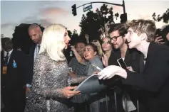  ??  ?? Lady Gaga meets fans at the premiere.