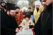  ?? REUTERS ?? Ecumenical Patriarch Bartholome­w of the Orthodox Church of Ukraine, attends a signing ceremony on Saturday.