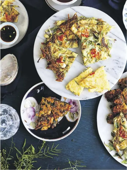  ?? LEELA CYD/COUNTRYMAN PRESS ?? Green onion and seafood pancakes make a quick and delicious snack or appetizer, says Kim Sunée, co-author of Everyday Korean: Fresh, Modern Recipes for Home Cooks.