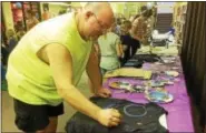  ?? EVAN BRANDT — DIGITAL FIRST MEDIA ?? Michael Heffner of Boyertown was one of hundreds of people who descended on the Pottstown Regional Public Library Friday to make a Galaxy shirt and get a free pair of eclipse glasses.