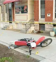  ?? BALTIMORE SUN FILE ?? A dirt bike is left on the sidewalk in April 2021 where a 14-yearold girl was shot in the leg, according to Baltimore Police. Might enforcemen­t of the city’s youth curfew reduce the number of such incidents?