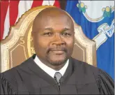  ?? John Marinelli Photograph­y / Contribute­d Photo ?? Richard A. Robinson made history on Monday as he was sworn in by Gov. Dannel P. Malloy as Connecticu­t’s first black chief justice of the state Supreme Court.