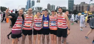  ??  ?? Tom Hutchinson (centre) with his running friends from Queens Park Harriers in London at the Chicago Marathon