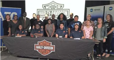  ?? ANNYSA JOHNSON / MILWAUKEE JOURNAL SENTINEL ?? Bradley Tech students (from left) Kiya Mooney, Jamaris Flowers, Ethan Sanchez and Debora Oquendo-Candelaria are surrounded by family members and supporters Wednesday after signing on to a youth apprentice­ship program at Harley-Davidson in Milwaukee.