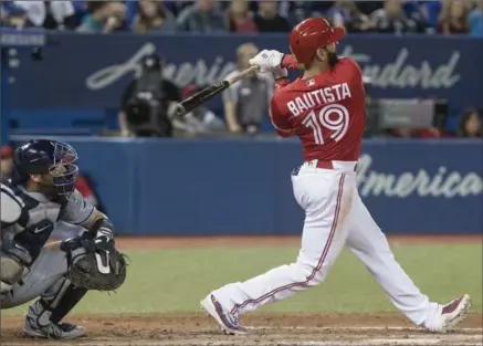  ?? FRED THORNHILL, THE CANADIAN PRESS ?? Toronto Blue Jays’ Jose Bautista hits a double Sunday to drive in the tying run in the eighth against the Tampa Bay Rays. Toronto won, 3-1.