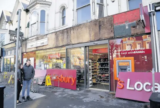  ??  ?? > The collapsed sign outside Sainsbury’s in the Uplands area of Swansea yesterday