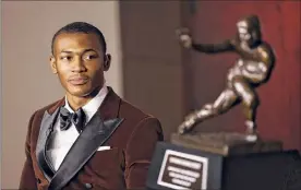  ?? Kent Gidney / Associated Press ?? Alabama wide receiver Devonta Smith finished with 447 first-place votes and 1,856 points to easily win the Heisman Trophy.
