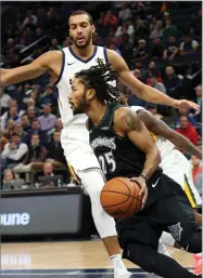  ?? AP PHOTO BY JIM MONE ?? Minnesota Timberwolv­es’ Derrick Rose drives around Utah Jazz’s Rudy Gobert during the second half of an NBA basketball game Wednesday, Oct. 31, 2018, in Minneapoli­s.