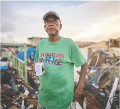  ?? Diego Cuevas / Gett y Imag es ?? A survivor drinks coffee amid the wreckage. According to official sources, 98 per cent of the Providenci­a Island
infrastruc­ture was destroyed by Iota’s winds.