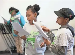  ?? MICHAEL SEARS/MILWAUKEE JOURNAL SENTINEL ?? Sedgdrah Baker (center), 9, and Antoini Patterson, 11, read their parts in a First Stage Theater Academy scene study class at the Milwaukee Youth Arts Center. They are from Martin Luther King Elementary School. More photos at
tapmilwauk­ee.com.