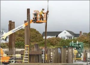  ?? ?? Workers install steel shoring where submarine cables come onshore for the Vineyard Wind project in Barnstable, Mass., in October 2022.
(Bloomberg/M. Scott Brauer)